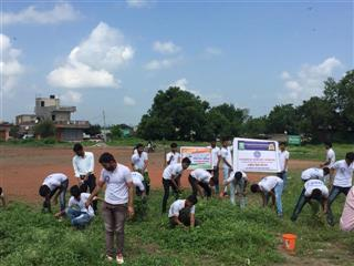 Students participating in field cleanliness drive